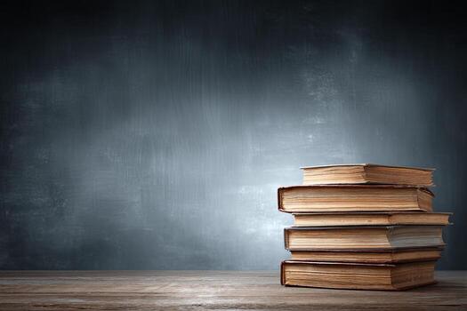 Stack of old books on wooden table photo