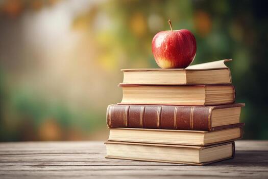Stack of books with apple, autumnal background photo
