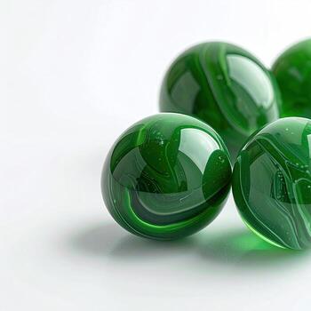 Close-up of several glossy, green marbles. Swirls of color within photo