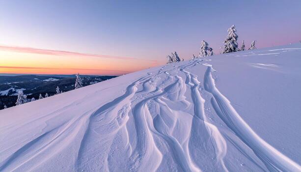 Snowy mountain ridge at dawn. Frozen patterns in the pristine snow. Soft pastel colors of sunrise photo