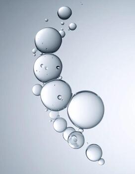Fluid, translucent bubbles, forming a graceful arc against a light gray background photo