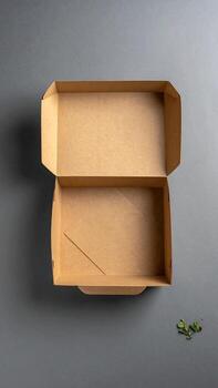 Open light brown cardboard food container on gray surface photo