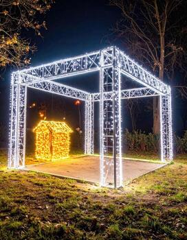 Illuminated square structure with warm-toned house photo