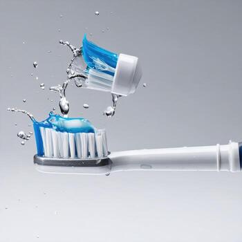 Electric toothbrush with toothpaste and water splash photo