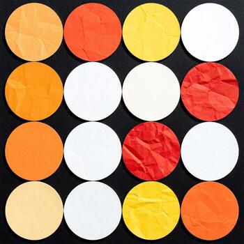 Circular paper shapes in vibrant colors on black photo