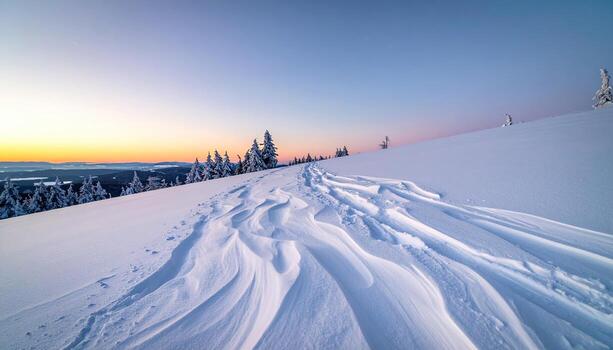Snowy mountaintop at dawn. Wind sculpted snow patterns photo