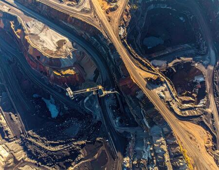 Aerial view of an open-pit mine, showcasing vast excavation, transport routes, and machinery photo