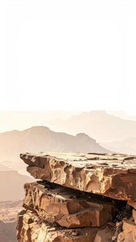 Rocky clifftop overlooking hazy mountains photo
