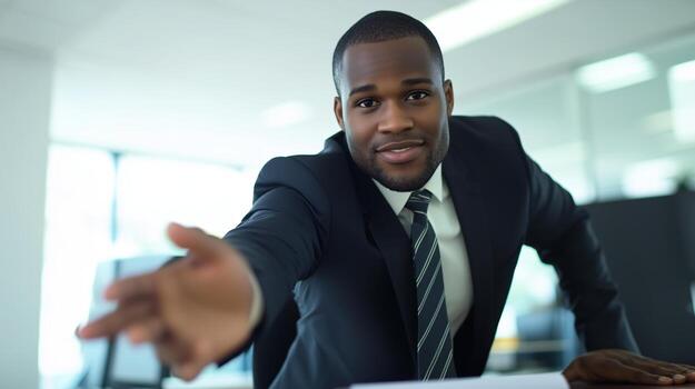 Business professional reaching out for a handshake in a modern office setting during a meeting photo