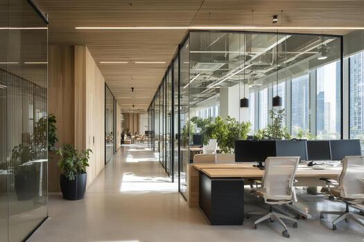 Modern office interior with glass partitions and greenery in a city setting during daylight photo