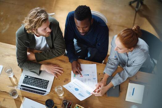 Collaborative team discussion over project reports in a modern office environment photo
