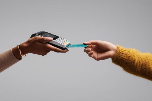 Payment transaction occurs with contactless card at a retail location during daylight hours photo