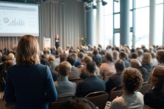 Audience engages in a presentation about data trends and analysis at a conference venue in an urban setting photo
