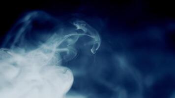 Blue Smoke Streams Flowing From Left And Dissolving In Dark Background. Flowing Blue Smoke Dissipating On A Black Background. video