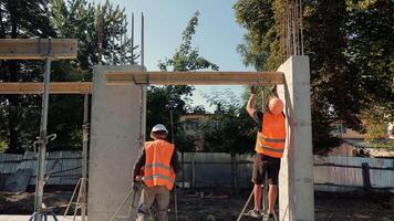 Construction Workers Installing Wall Formwork, Team In Safety Vests Adjusts Supports And Frames For Concrete Pouring, Active Work Scene On Building Site video