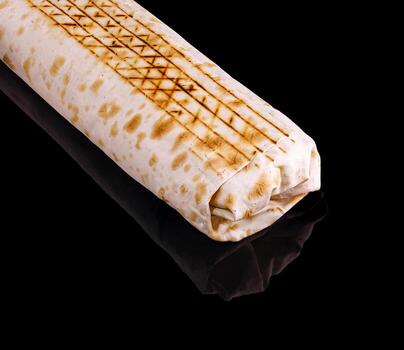 Grilled flatbread wrap with distinct patterns on glossy surface photo