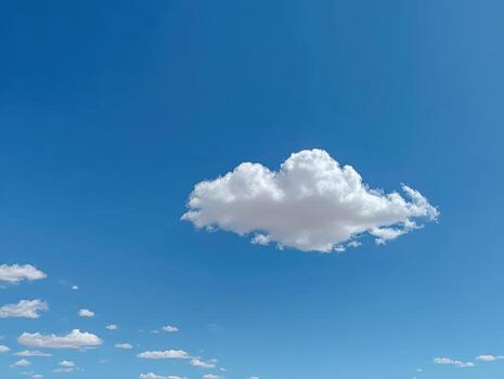A cloud is floating in the sky above a desert photo