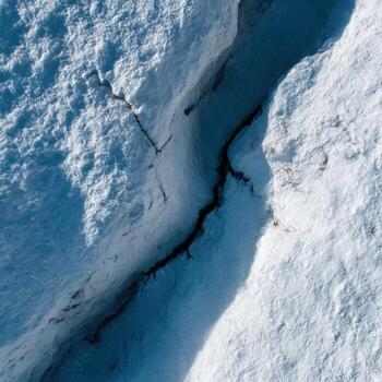 A close up of a snow covered rock photo