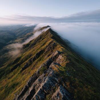 A view of the mountains from above with low clouds photo