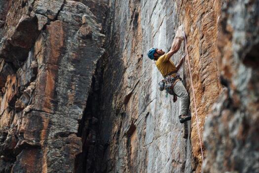 A man climbing on a rock face photo