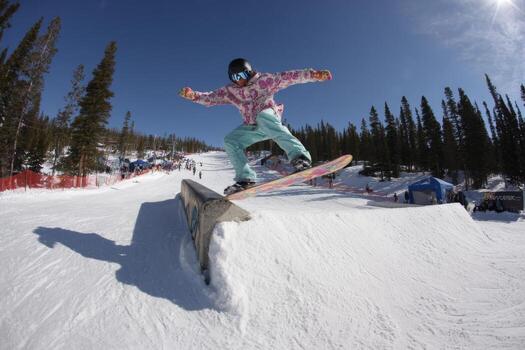 A person riding a snowboard down a ramp photo