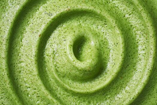 A green smoothie with a swirl pattern photo