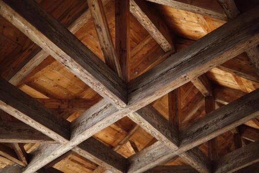 The ceiling of a wooden building with beams photo