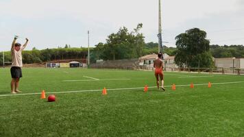 Engaging and Dynamic Training Session Conducted on the Field Using Cones and an Exercise Ball video