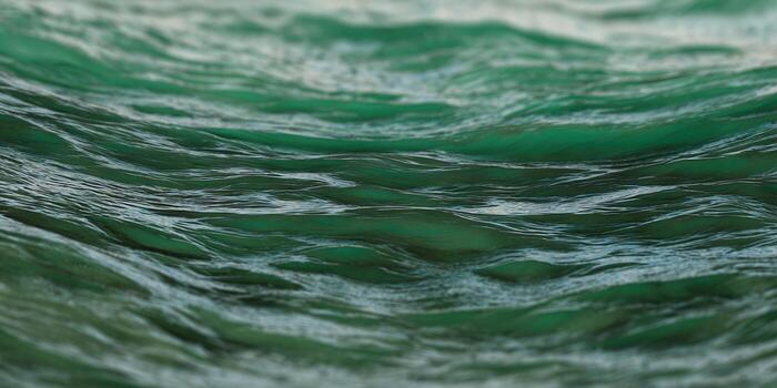 Captivating close-up of turquoise ocean waves with mesmerizing textures and fluid motion. photo
