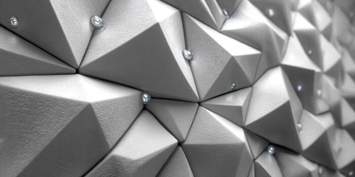 Intricate geometric wall design with textured surface and metallic studs. photo
