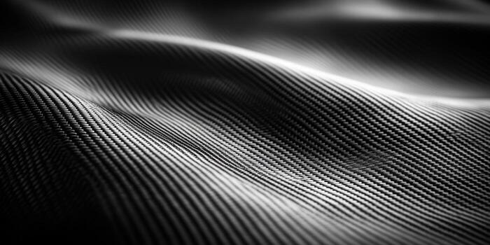 Close-up of a textured carbon fiber surface, exhibiting a sleek, modern pattern. photo