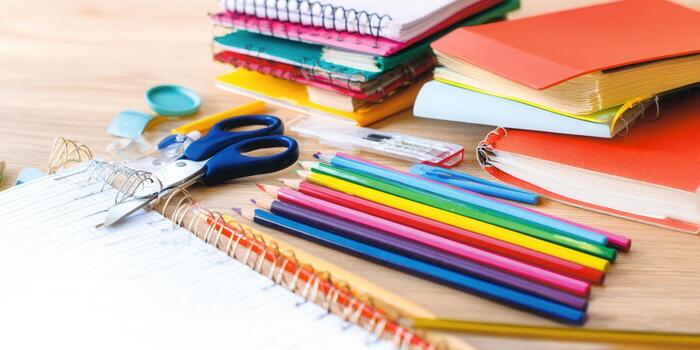 A vibrant display of school essentials, including colorful pencils and notebooks, ready for learning. photo