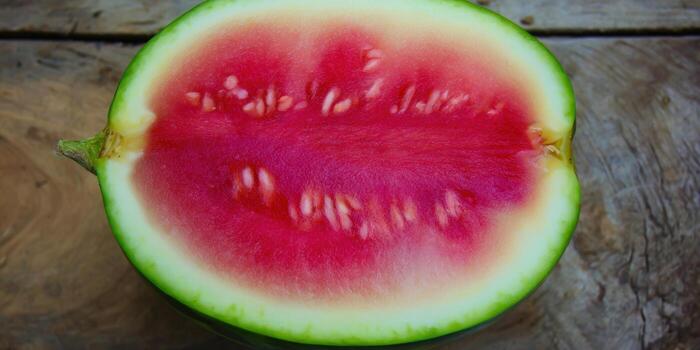 Freshly cut watermelon showing its vibrant red flesh and seeds, perfect for summer refreshment photo