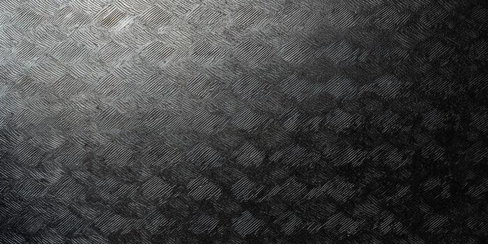 A textured, dark metal surface with an interwoven, repeating geometric pattern. photo