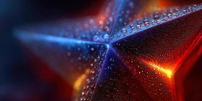 Close-up of a star with water droplets, illuminated with blue and red light. photo
