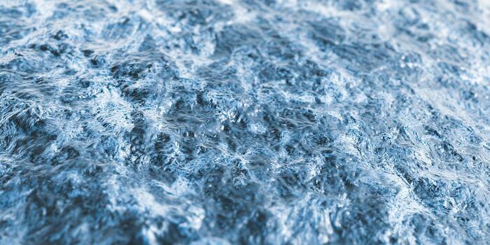 An abstract view of water, featuring dynamic waves and beautiful blue hues. photo