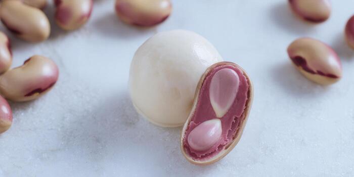 A macro shot showcasing fresh, healthy beans. The beans' detail is highlighted against a white backdrop. photo
