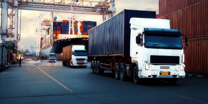 Trucks loaded with cargo containers at the port, ready for global shipping and trade. photo