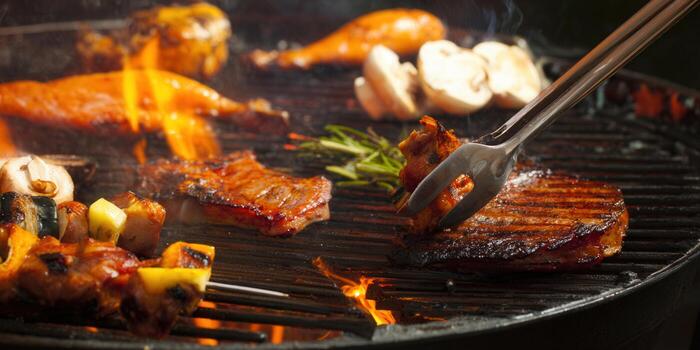 A close-up shot of a barbecue grill with various grilled foods on display, capturing a tasty scene. photo
