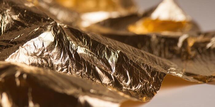Detailed shot of golden leaf with intricate textures and exquisite shine. photo