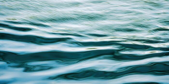 Gentle water waves create a mesmerizing display of blues and greens, perfect for a serene backdrop. photo