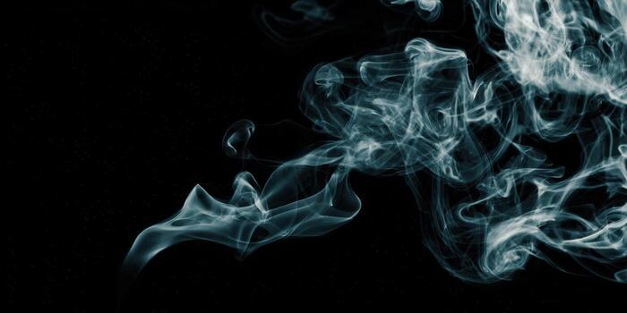 Ethereal wisps of smoke dance against a black background, creating a mystical abstract design. photo