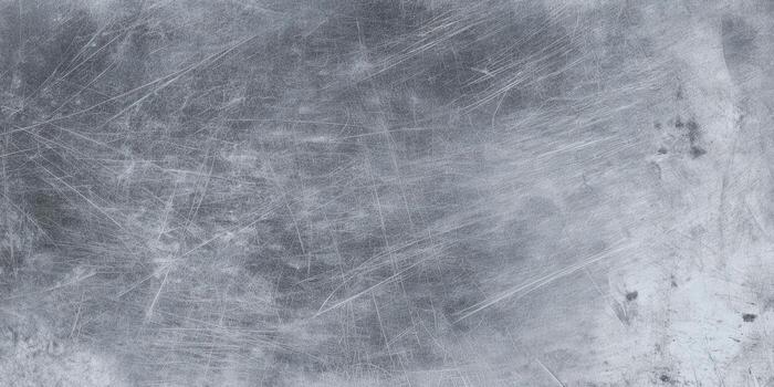 Detailed view of a heavily scratched metal surface with a textured, worn appearance photo