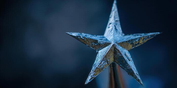 A striking metallic star, gleaming against a deep blue, creates a captivating visual. photo