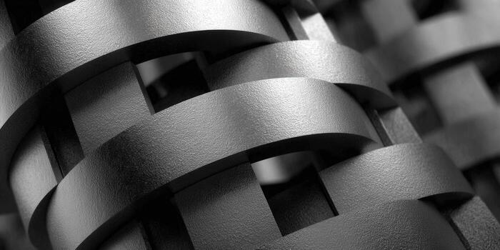 A close-up of an abstract, interwoven design with textured, metallic bands in grayscale. photo