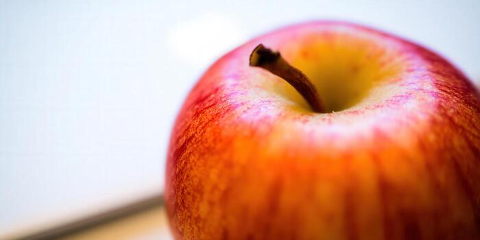 A captivating close-up showcases the rich colors and textures of a ripe red apple. photo