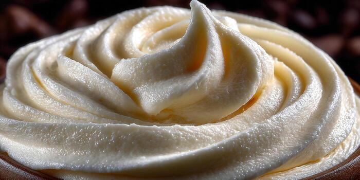 Close-up view of beautiful buttercream frosting swirls, ready to decorate a cake or cupcake. photo