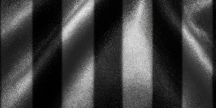 Elegant fabric with a black and white striped pattern, featuring a smooth and shimmering texture. photo