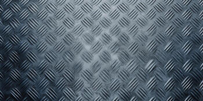 This close-up presents the textured surface of a diamond plate metal, suitable for various applications. photo
