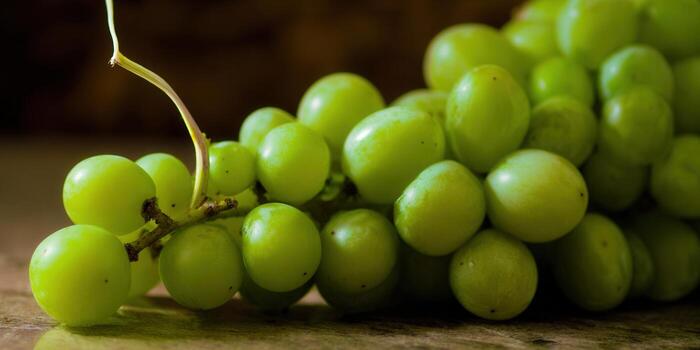 A vibrant close-up showcases a cluster of fresh, green grapes, ready to be enjoyed. photo
